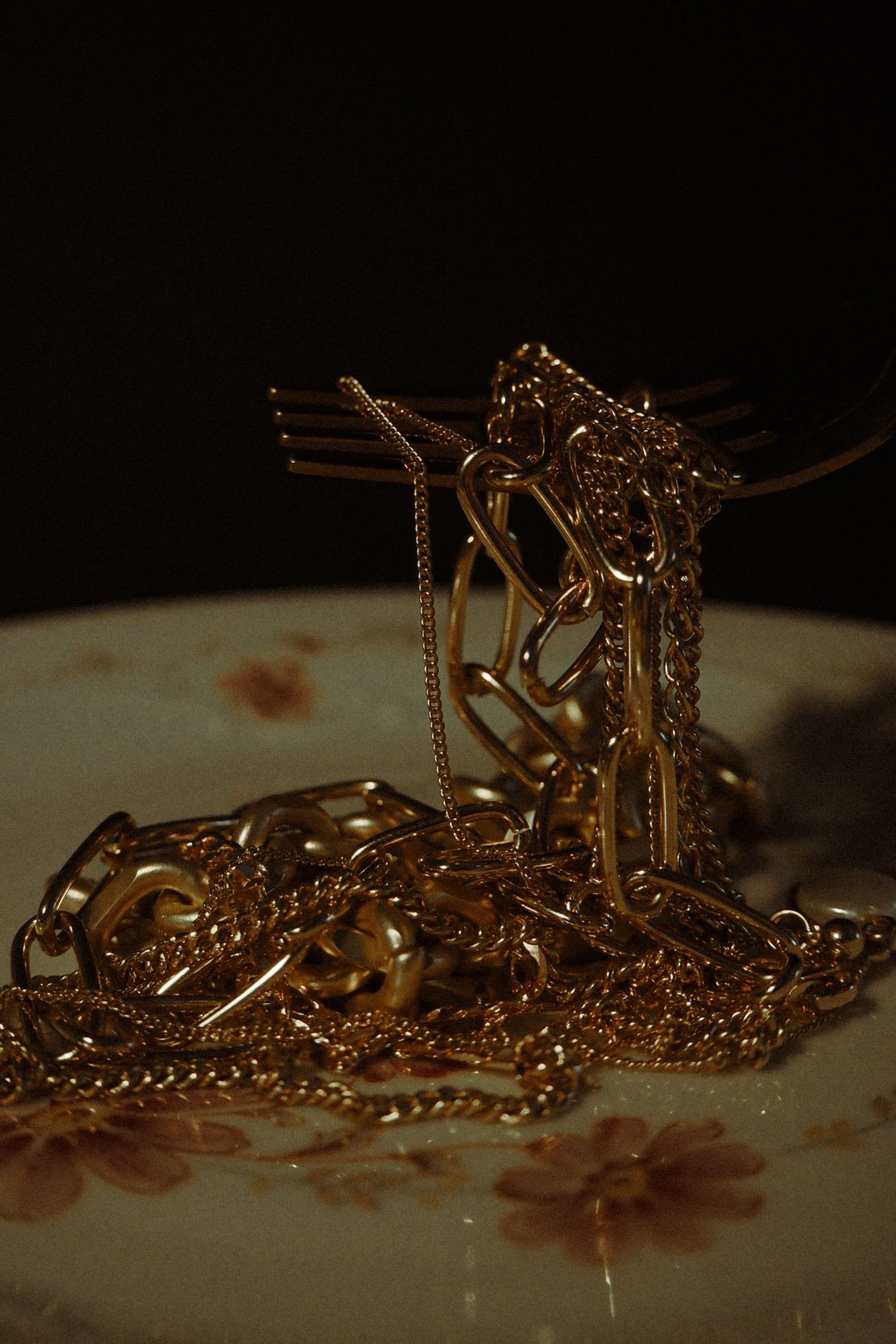A tangle of gold chains on a patterned plate